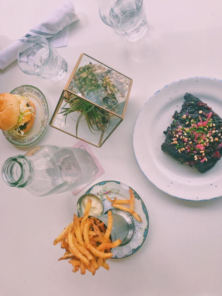 The standard burger, house cut fries, worst ribs in town, water in milk glass, and terrarium.